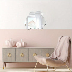 Modern interior design with a light gray cabinet, beige chair, and decorative pumpkins against a pink wall.