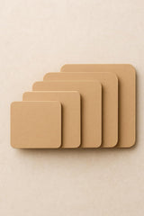 Set of five beige square placemats on a beige background