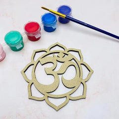 Decorative Om symbol with paint jars and a brush on a light background