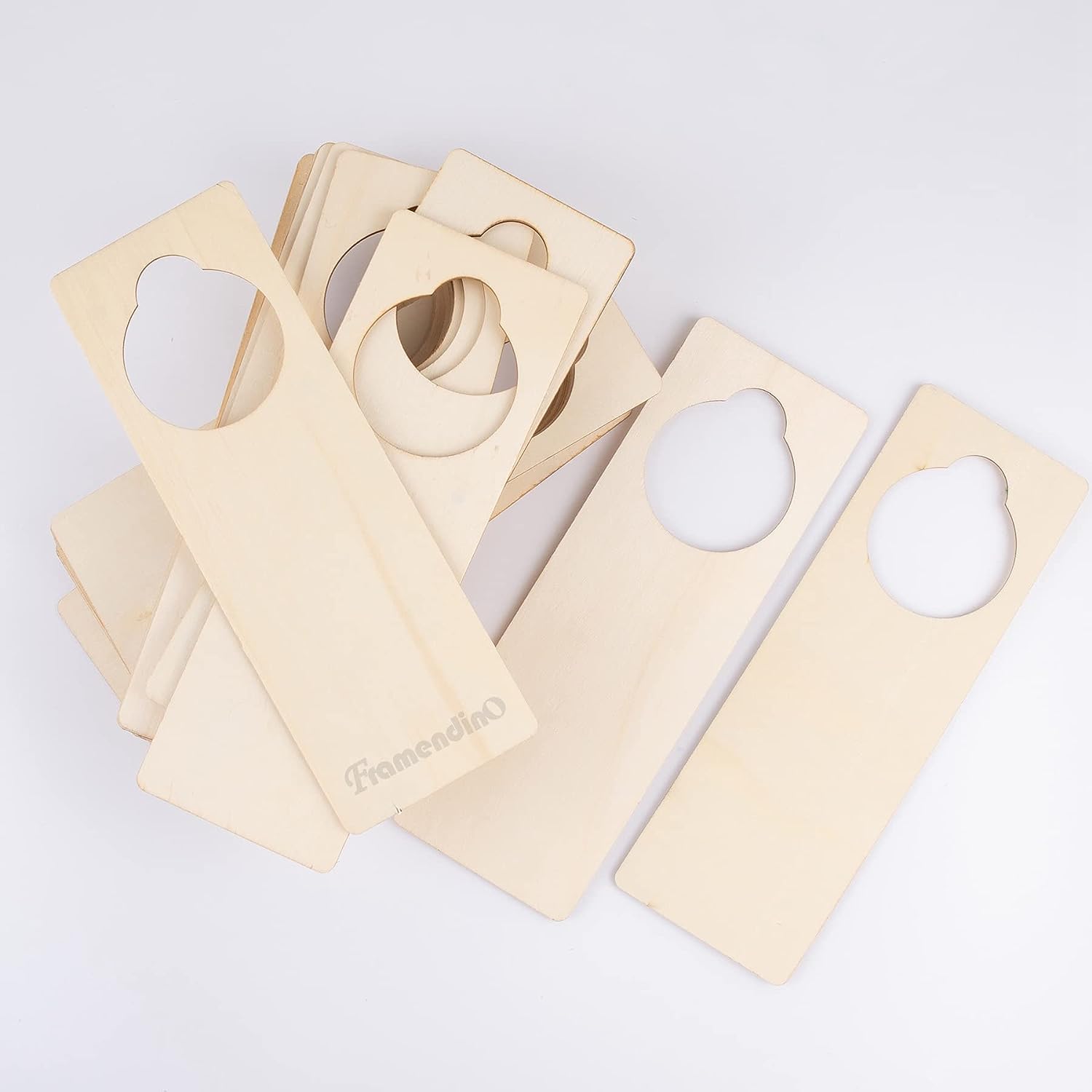 Beige wooden door hangers with heart cutouts on a white background