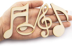 Wooden music note shapes held in a hand on a white background