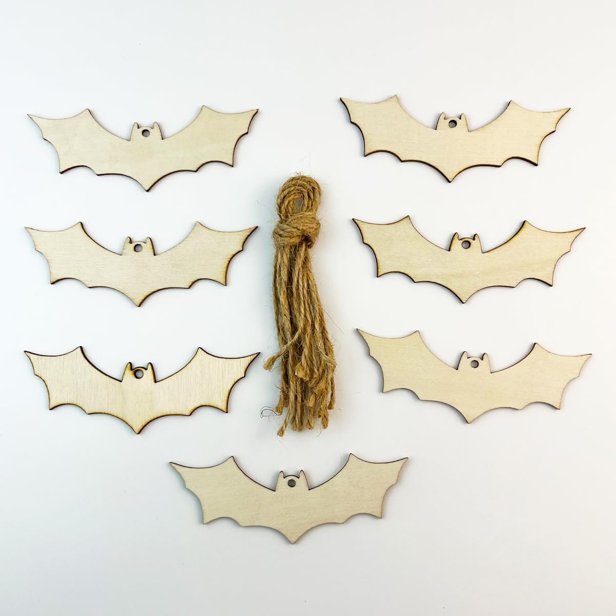 Wooden bat shapes with a string on a white background