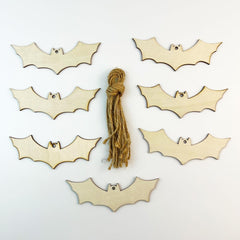 Wooden bat shapes with a string on a white background