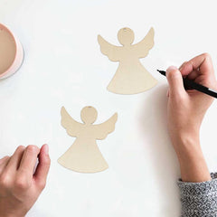 Wooden angel shapes with hands using a marker on a white background