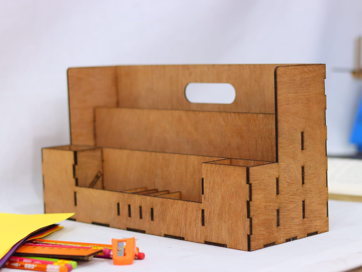 Cardboard storage box with a white handle on a white surface