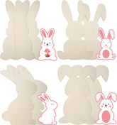 Four wooden bunny cutouts with pink bunny stickers on a white background