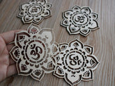 Wooden laser-cut mandala designs on a wooden surface