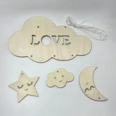Wooden cloud-shaped decoration with 'LOVE' letters, star, cloud, and moon shapes on a light gray background.