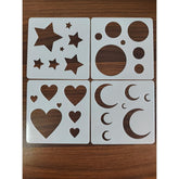 Set of stencils with star, circle, heart, and moon designs on a wooden surface.