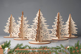 Set of wooden Christmas tree decorations on a gray background