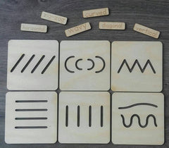 Set of wooden stencils with different patterns on a wooden surface