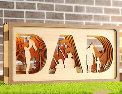 Wooden decorative sign with 'DAD' cutout, featuring images of a father and child, against a brick wall.
