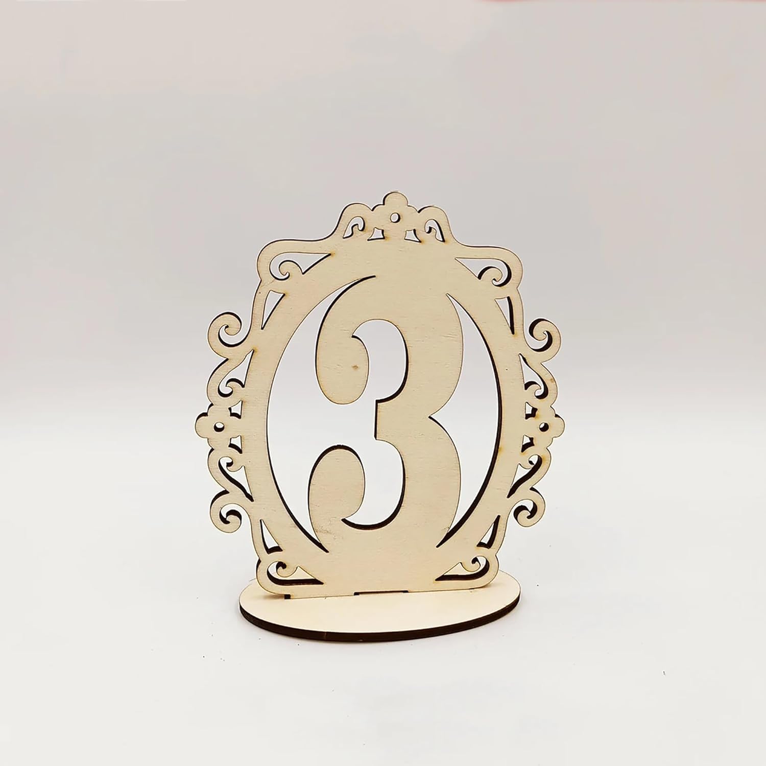 Decorative wooden table number '3' on a light gray background