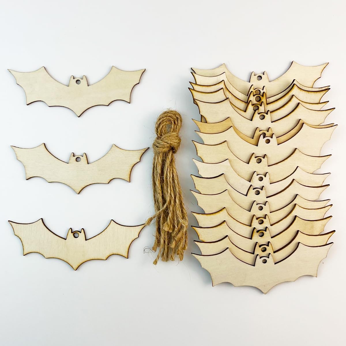 Wooden bat decorations with a tassel on a light background