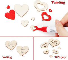 Wooden heart-shaped decorations with red and white paint, and a hand writing 'Thank You' on one of them.