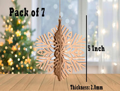 Wooden snowflake ornament with measurements and a Christmas tree in the background