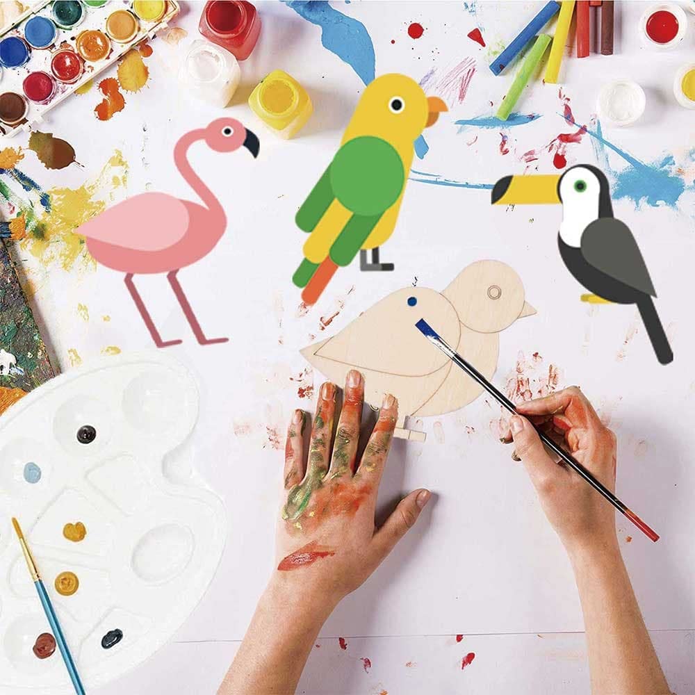 Children's art project with painted animal figures and paint supplies on a white surface.