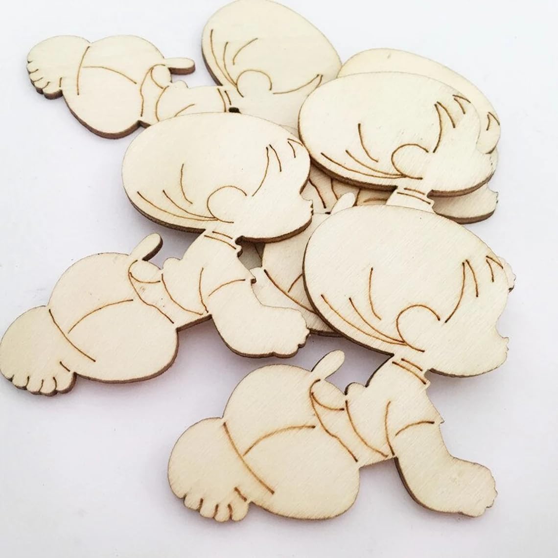 Wooden cutouts of cartoon characters on a white background