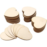 Stacks of heart-shaped wooden cutouts on a white background