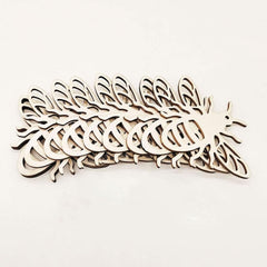 Stack of wooden feather-shaped cutouts on a white background