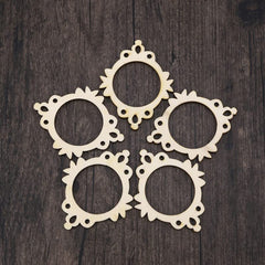 Five decorative beige frames on a dark wooden surface