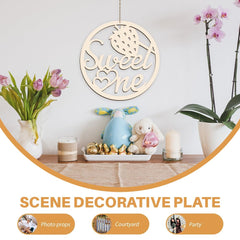 Decorative plate with 'Sweet One' text, surrounded by flowers and small toys on a wooden surface.