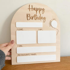 Wooden birthday card with text and space for writing on a wooden surface.