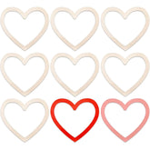 Nine beige heart-shaped cookie cutters with two red and one pink heart-shaped cookie cutter on a white background.