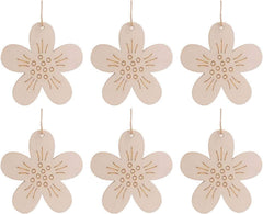 Set of six wooden flower-shaped ornaments with string loops on a white background