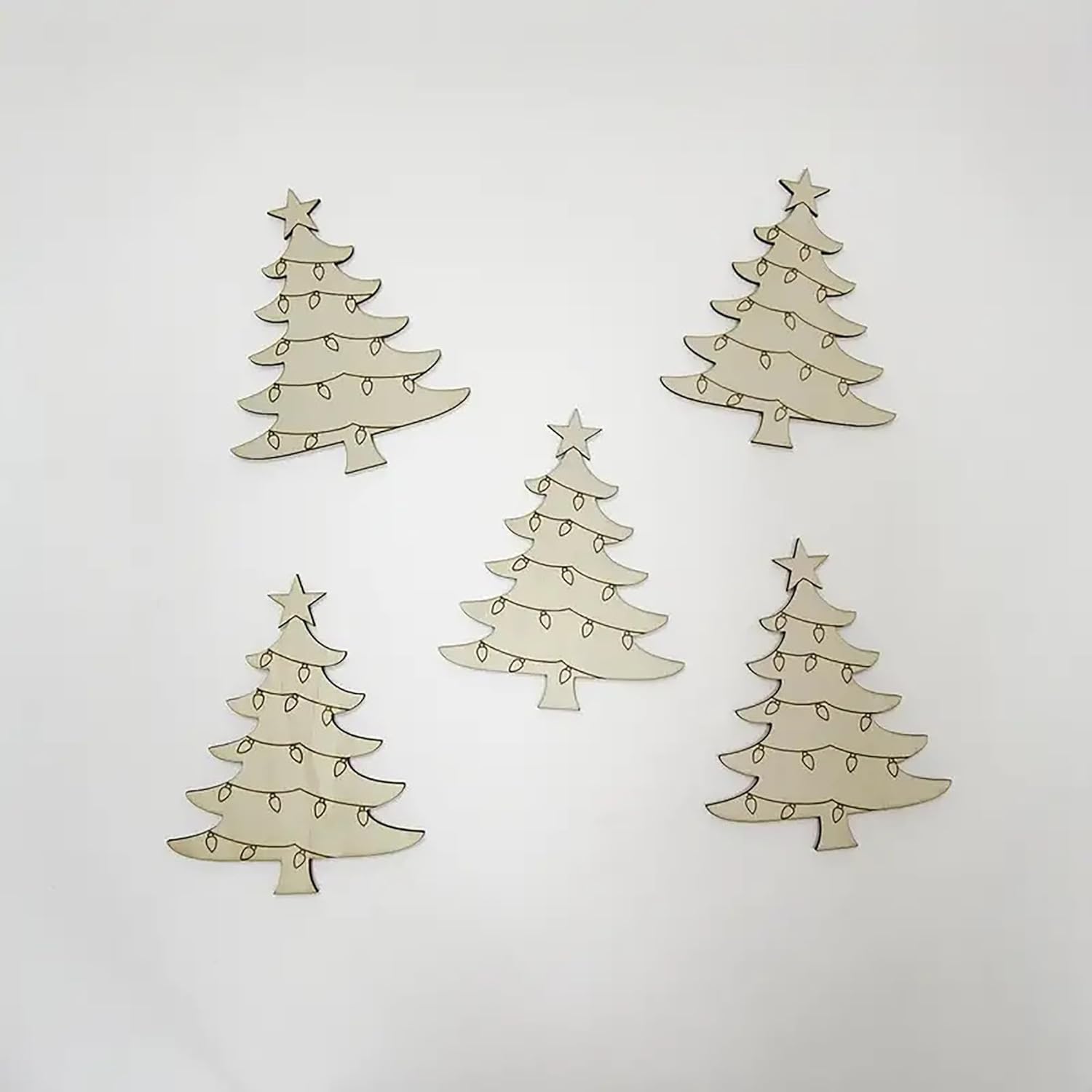 Four Christmas tree-shaped decorations with lights and stars on a light gray background