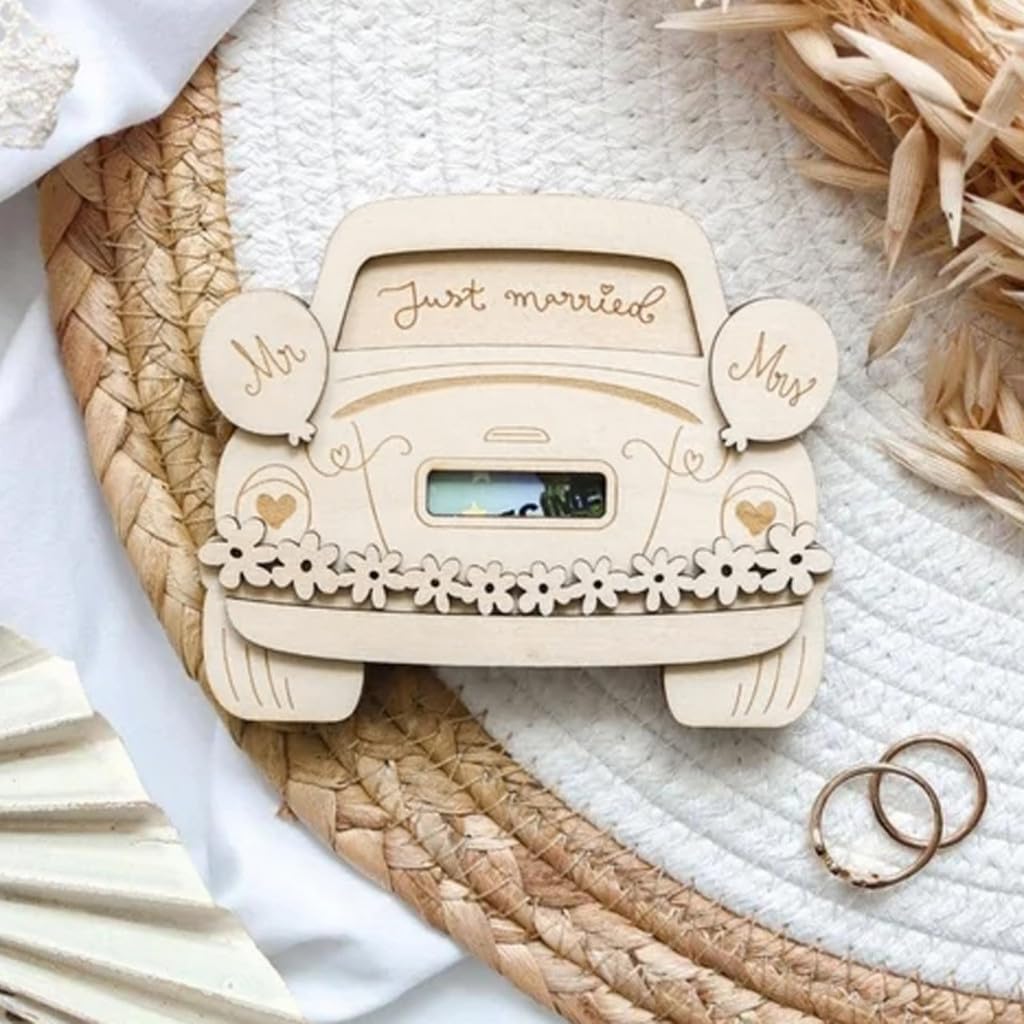 Wooden car-shaped photo frame with 'Just married' text on a textured surface.