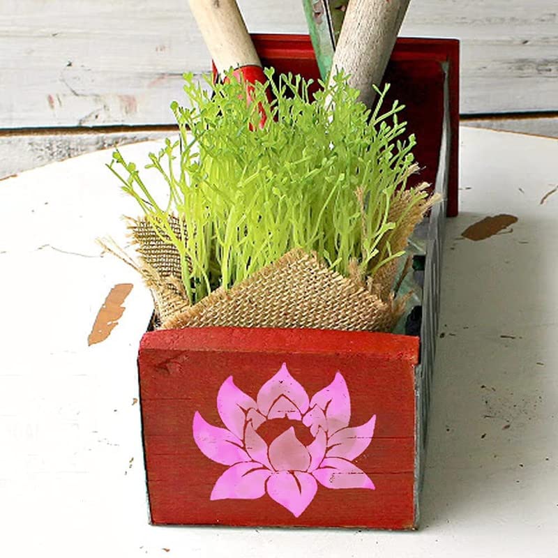 Red wooden planter with green plants and a pink lotus design on a white background
