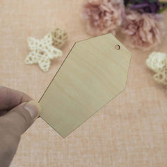 Hexagonal wooden tag held by a hand with a floral background