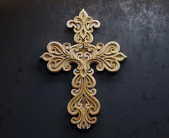 Decorative cross with intricate patterns on a dark background