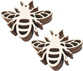 Two wooden bee-shaped cutouts on a white background