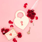 Heart-shaped lock, roses, and a letter on a pink background