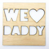 Wooden plaque with 'WE LOVE DADDY' text on a white background