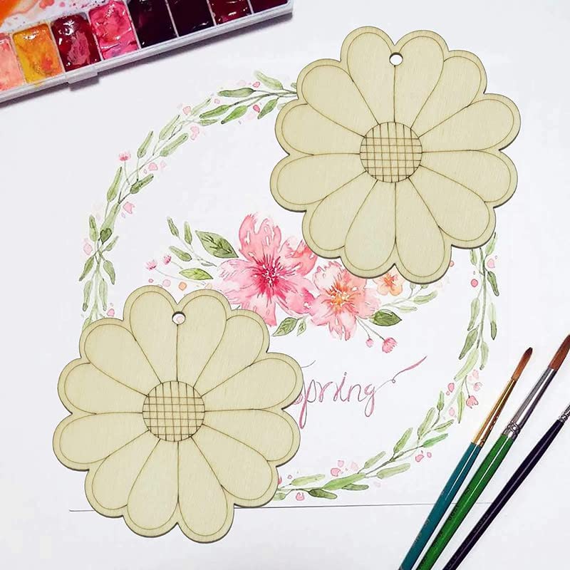Floral design with daisies and pink flowers on a white background, surrounded by watercolor paints and brushes.