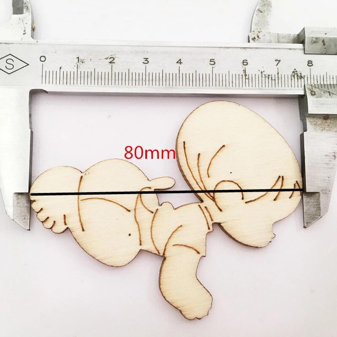 Wooden mold of a baby's feet with a caliper measuring 80mm.