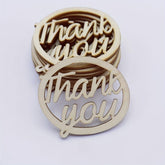 Wooden 'thank you' cutouts on a white background