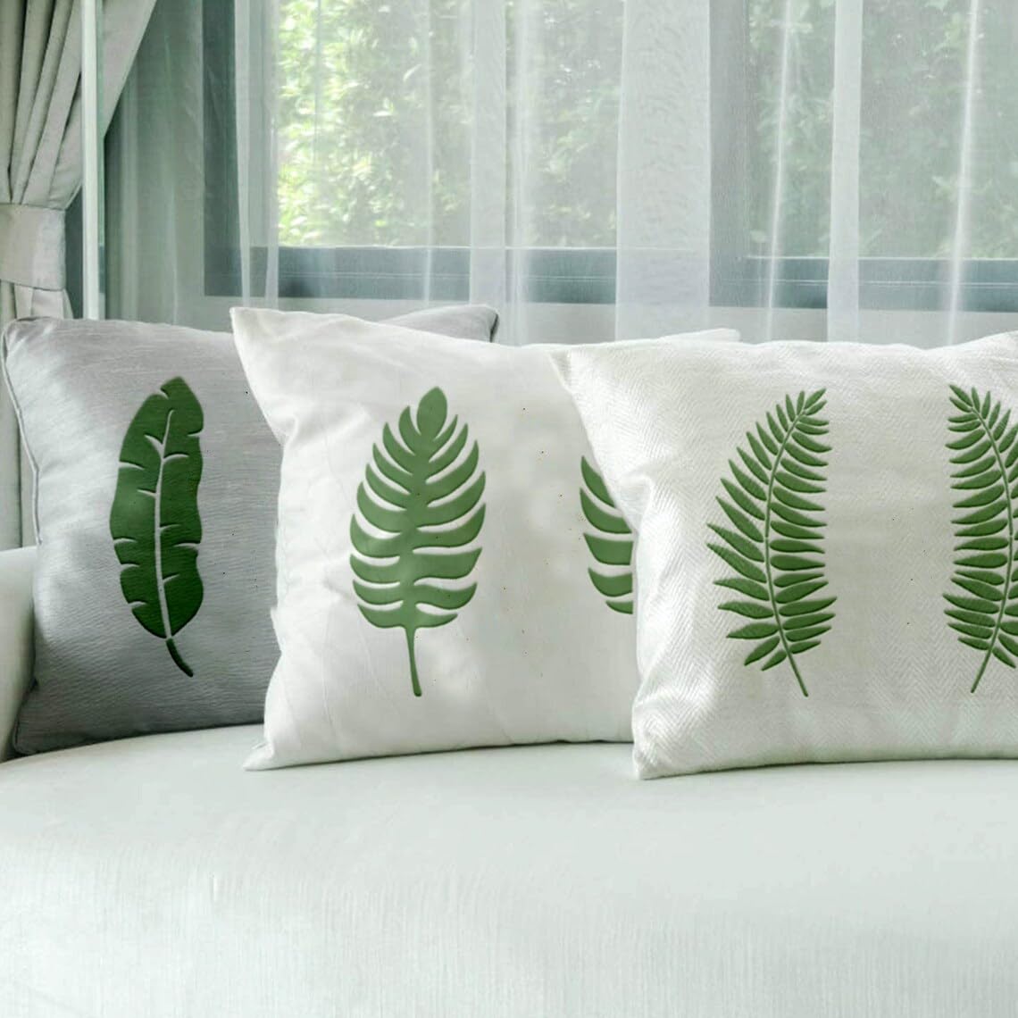 Decorative pillows with leaf patterns on a bed