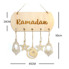 Decorative hanging sign with 'Ramadan' text and hanging charms on a white background