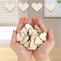 Hands holding wooden heart shapes with a neutral background