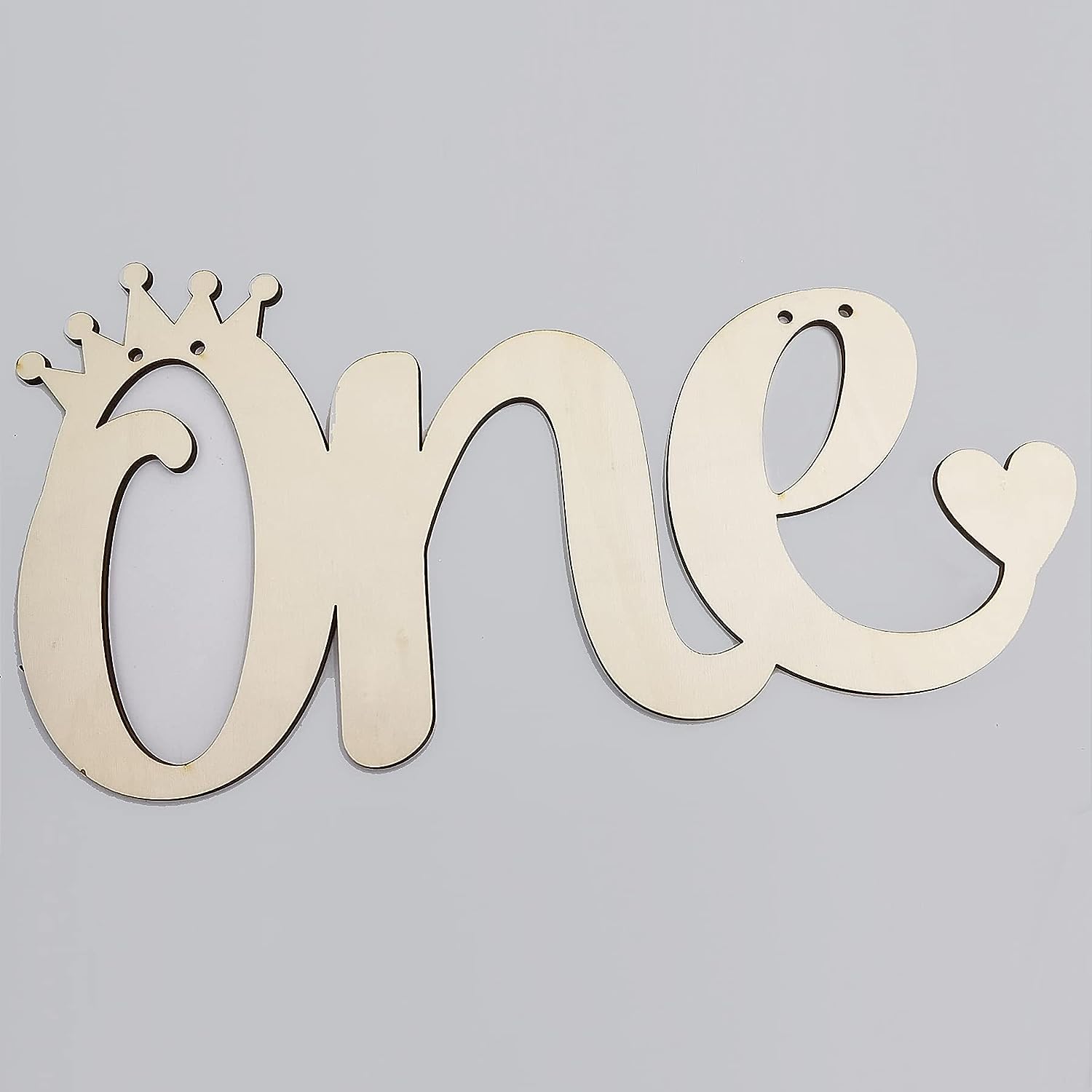 Wooden decorative sign with 'one' and a crown on a gray background
