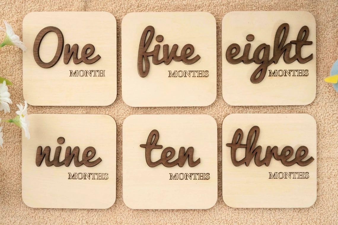 Six wooden cards with text indicating months on a textured surface.