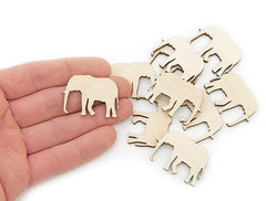 Wooden elephant cutouts on a white background with a hand holding one.