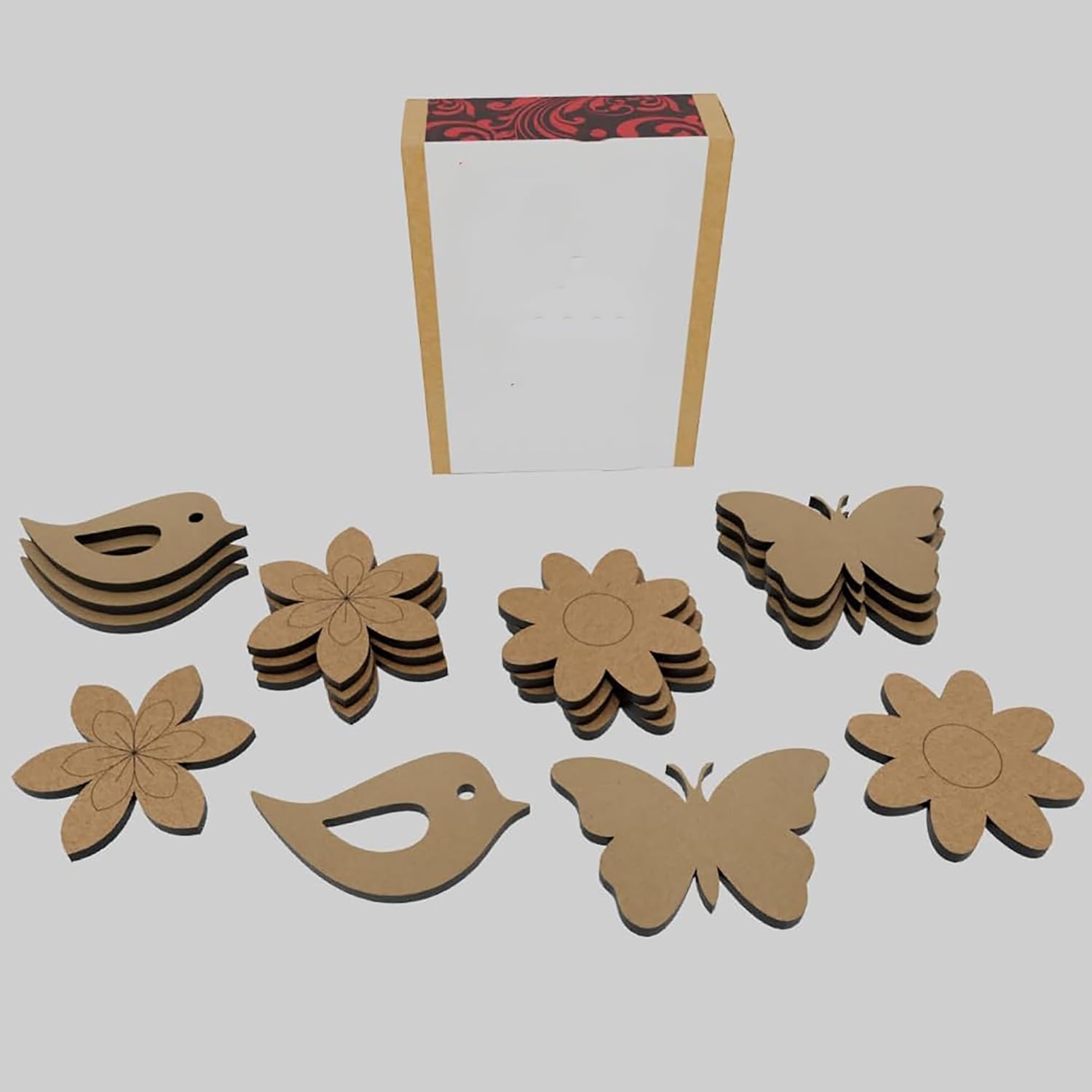 Cardboard cutouts of birds, flowers, and butterflies on a white background