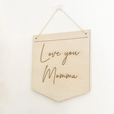 Beige wall hanging with 'Love you Momma' text on a white background