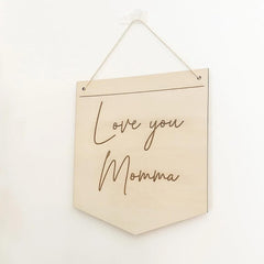 Beige wall hanging with 'Love you Momma' text on a white background