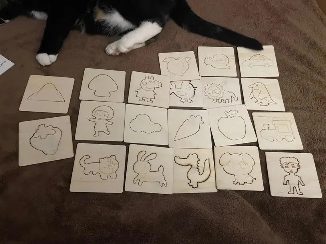 Set of wooden stamps with various shapes and designs on a brown surface, with a cat partially visible.